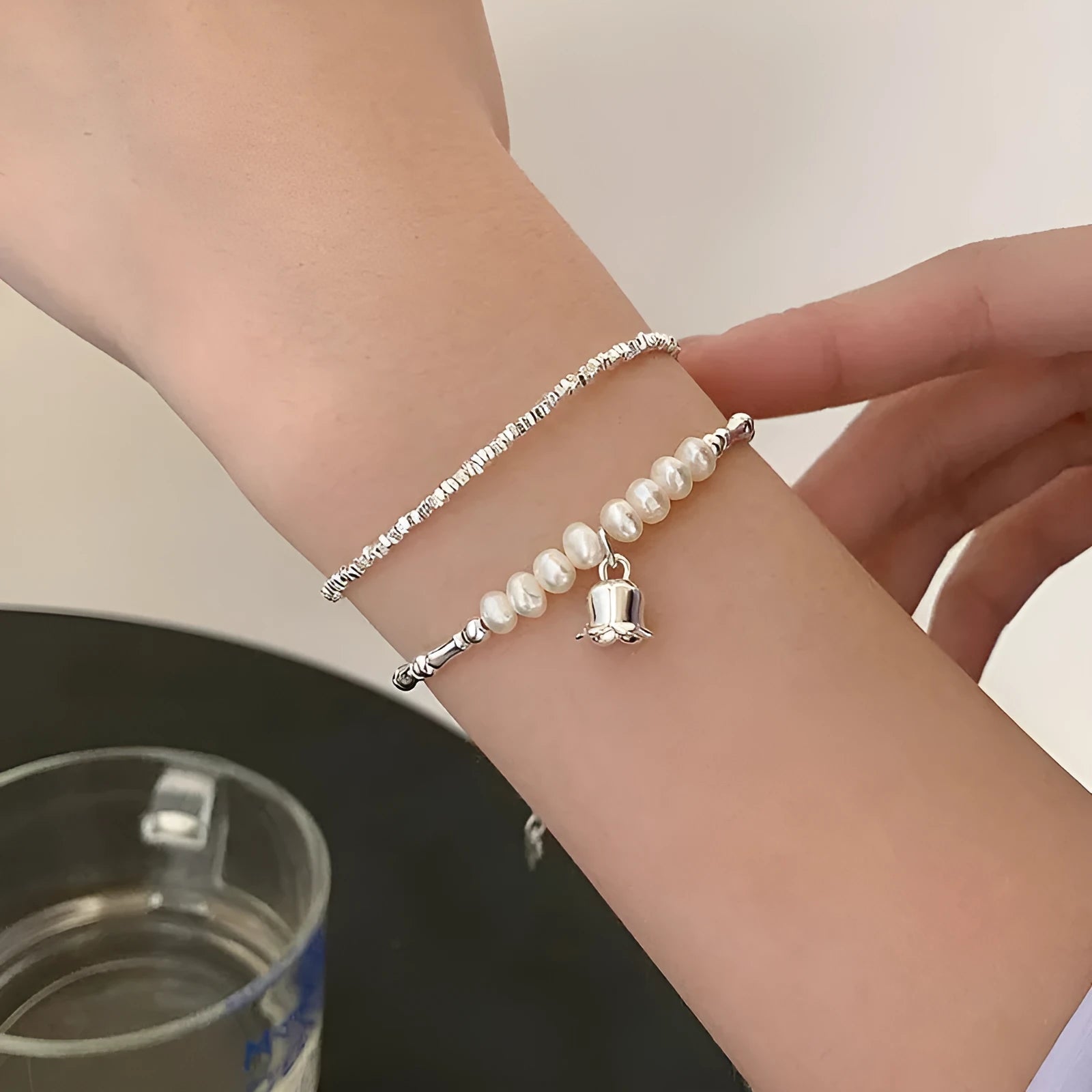 Silver pearl Lily of the Valley pendant bracelet on display