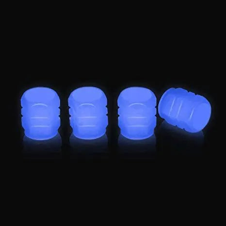 Luminous rubber tyre valve caps in light green, blue, red, yellow, and pink colours on a wheel valve.