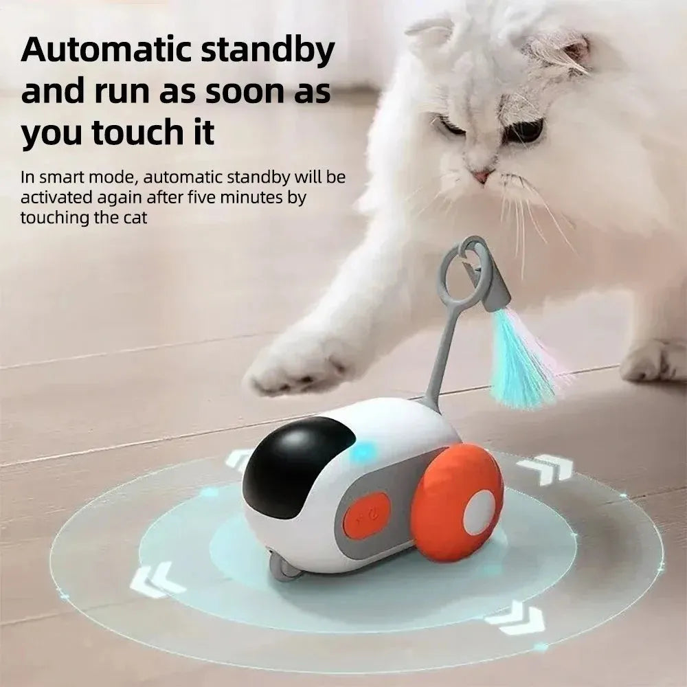 Blue interactive cat toy car with feather attachment and remote control on wooden floor
