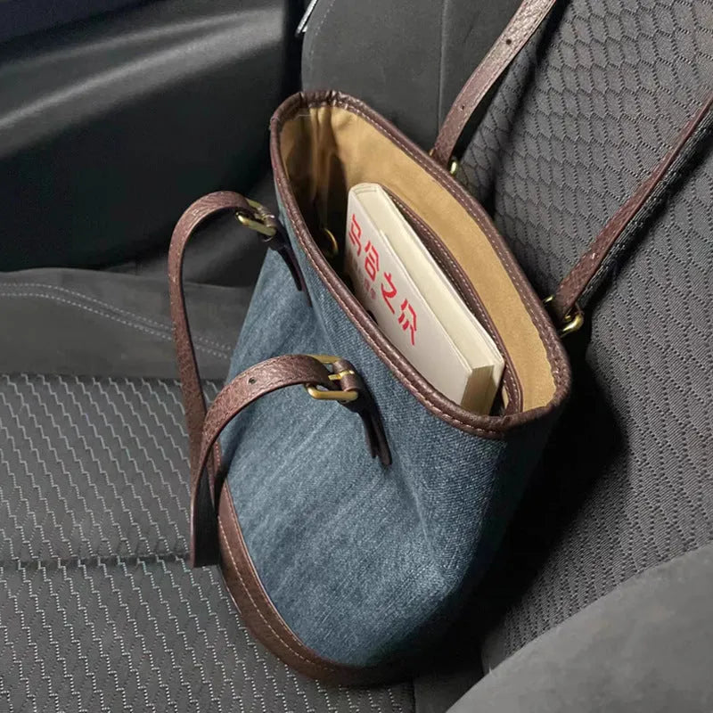 Denim patchwork one-shoulder bucket handbag showing 23x27x16cm dimensions and polyester construction