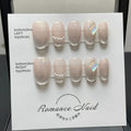 Women's handmade blush colour short artificial nail manicure set showing sizes XS, S, M, L.
