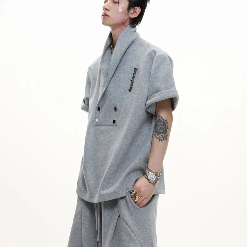Men's dark grey cotton sports suit with V-neck short sleeve top featuring padded shoulders and metal embellishments with matching shorts