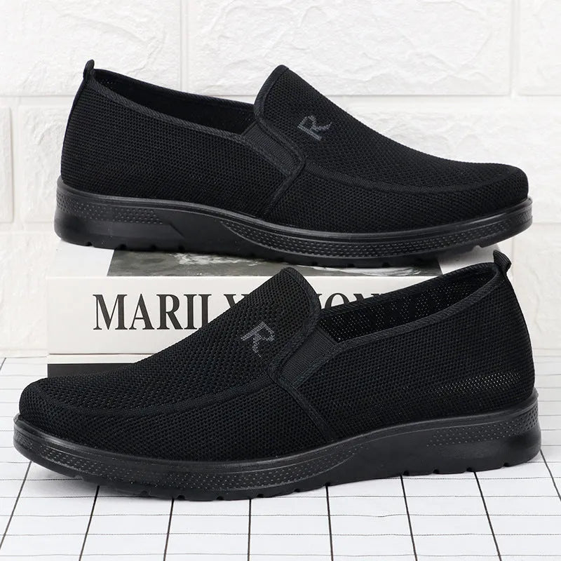 Men's black polyurethane slip-on shoes with breathable mesh upper and flat heel for casual wear
