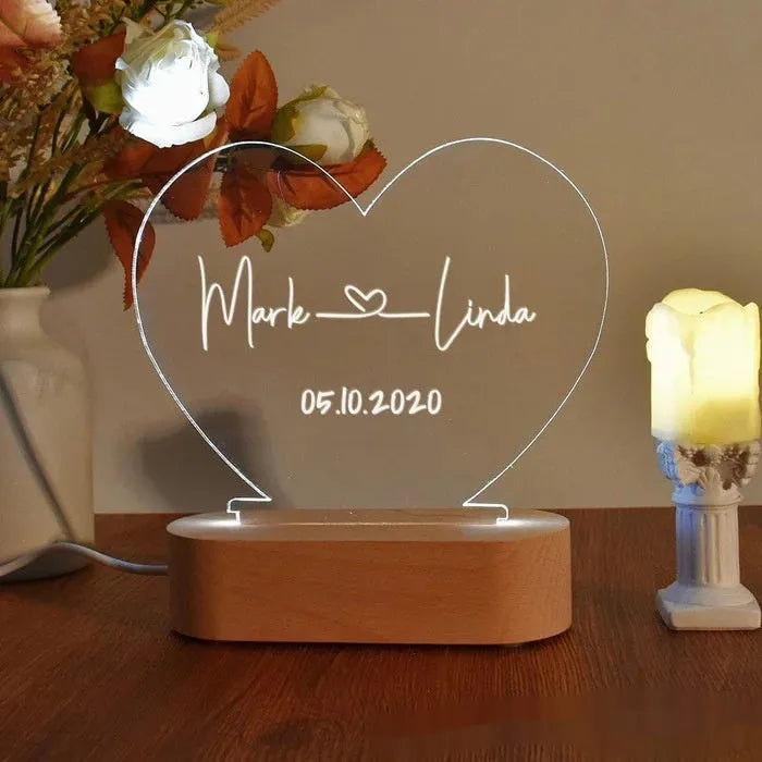 Personalised acrylic night light with engraved names and date, measuring 20cm by 11.5cm