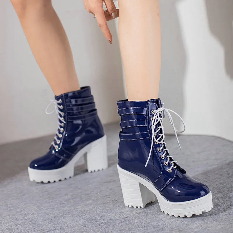Women's black ankle boot with a thick rubber heel, round toe, and front lace-up closure on a waterproof platform.