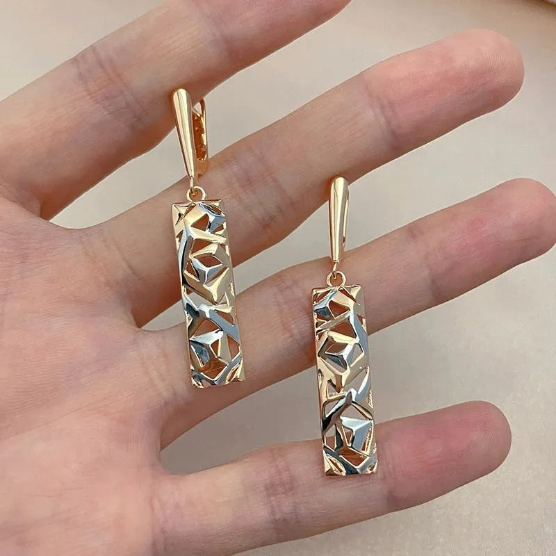 A pair of rectangular two-tone hollow stud earrings with a geometric shape and electroplated finish.