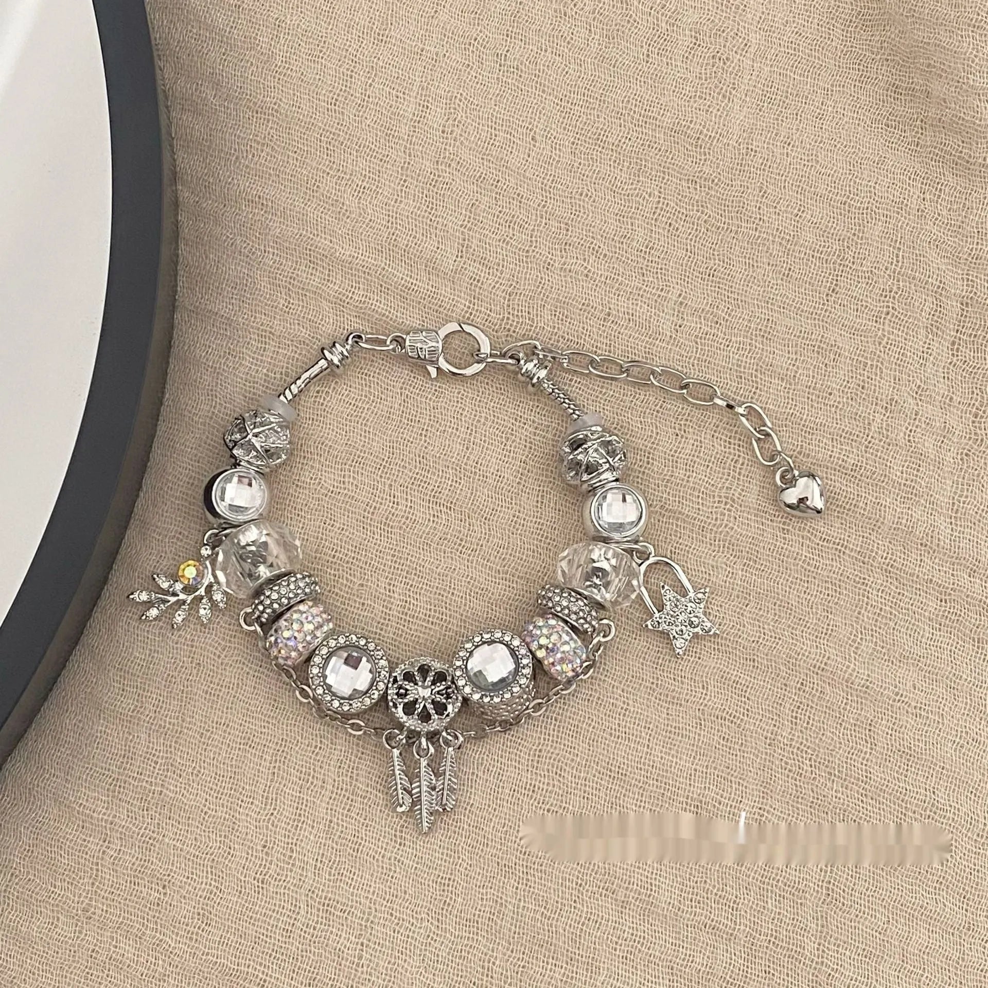 Women's dream catcher star bracelet with colourful crystals and electroplated finish on a white background