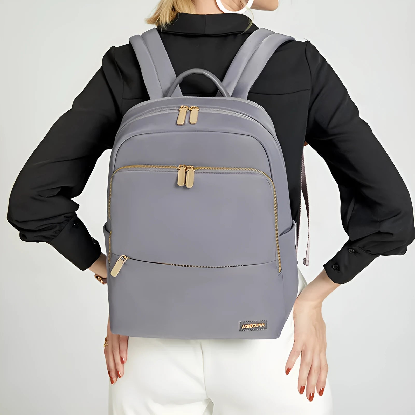 Women's large capacity oxford cloth backpack in black, showing front compartments and shoulder straps.