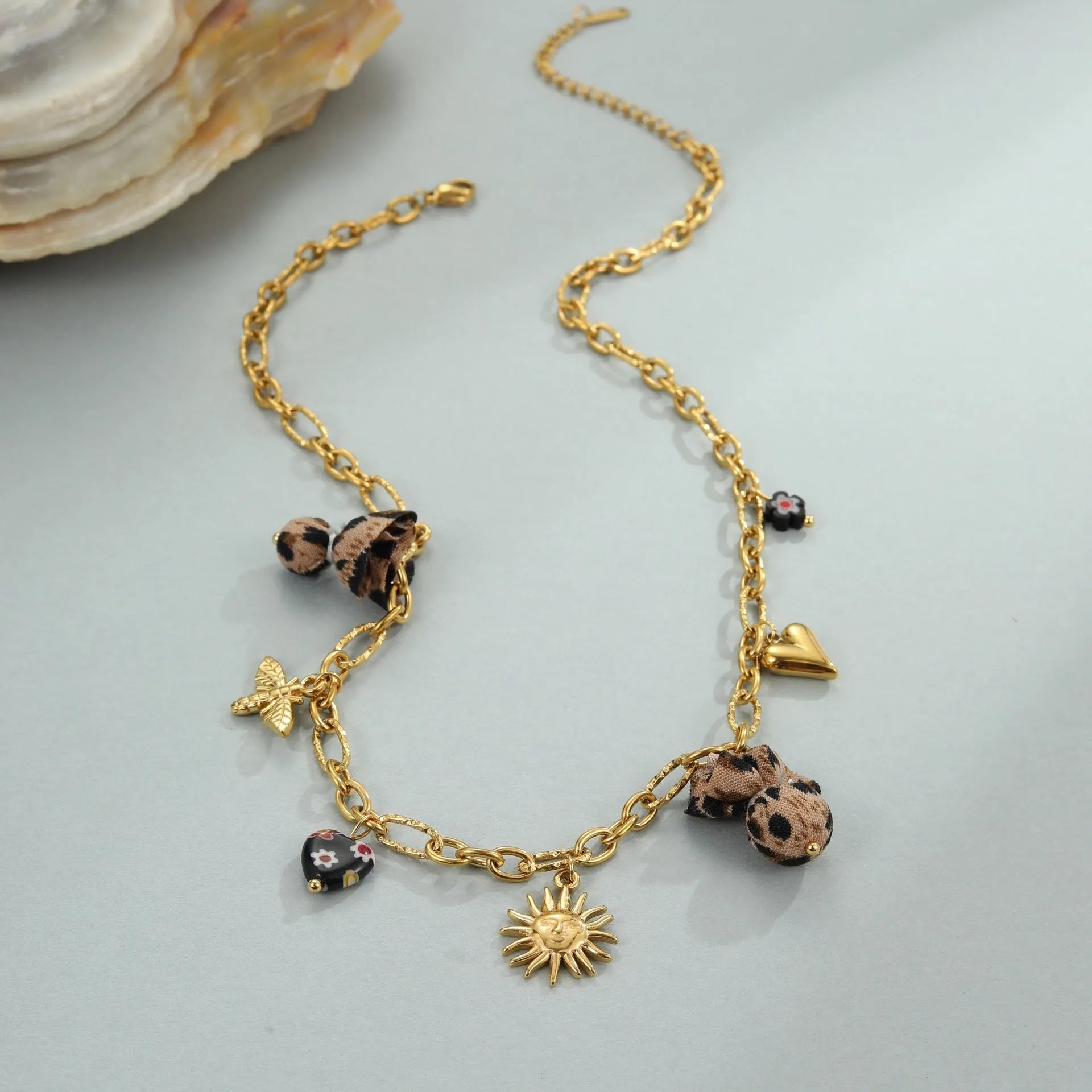 Women's stainless steel necklace with geometric leopard pendant featuring love heart and floral details on adjustable chain