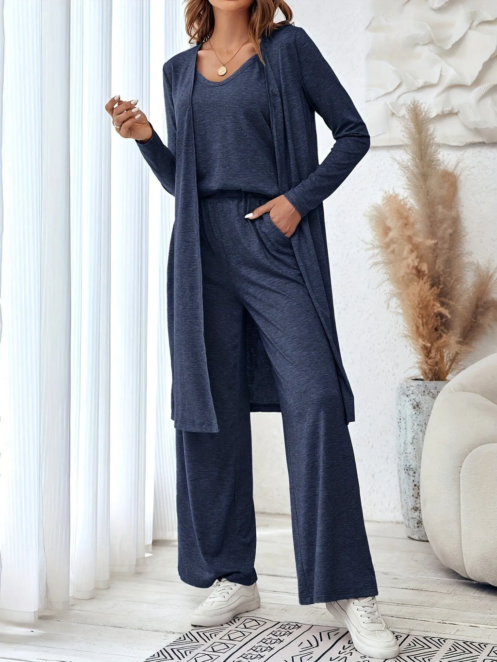 Blue women's three-piece co-ord set with sling top, long cardigan, and trousers on a hanger.