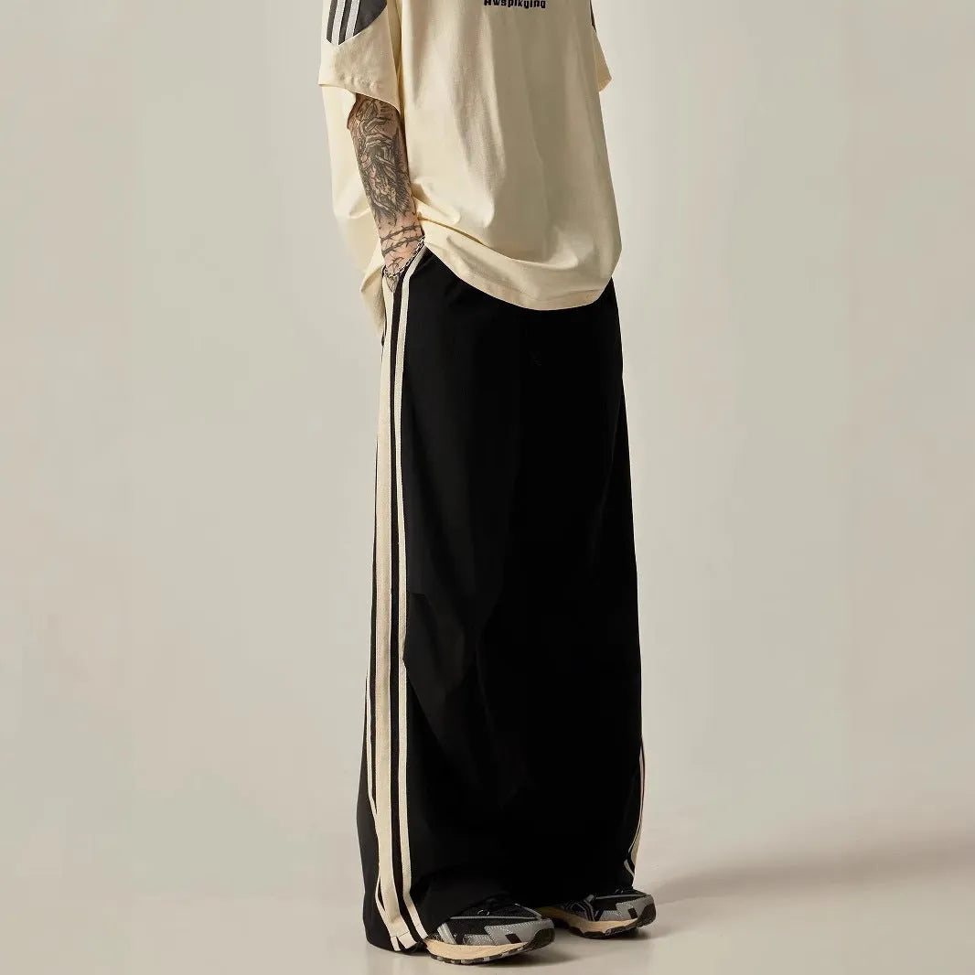 Man wearing black high-waist wide leg climbing pants made from polyester for casual leisure wear.