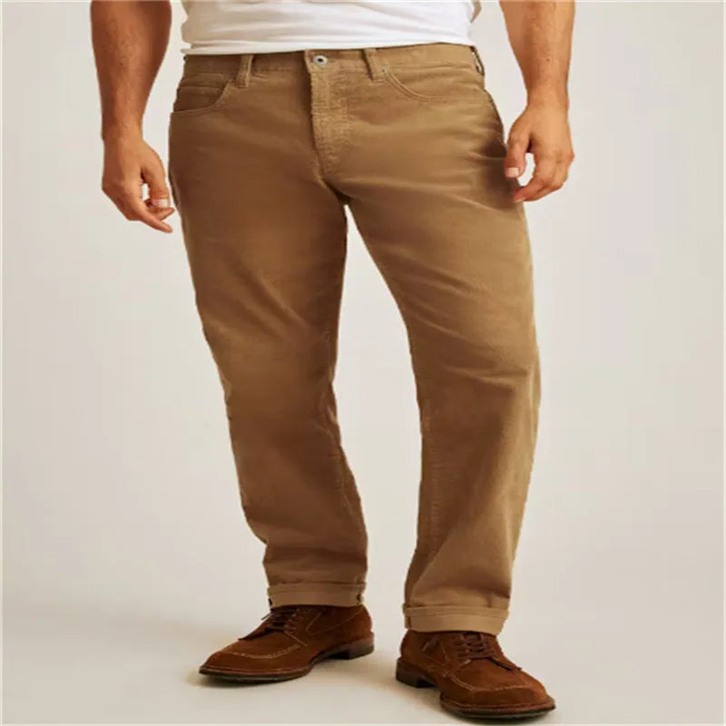 Man wearing loose fit straight-leg corduroy trousers in a solid colour.