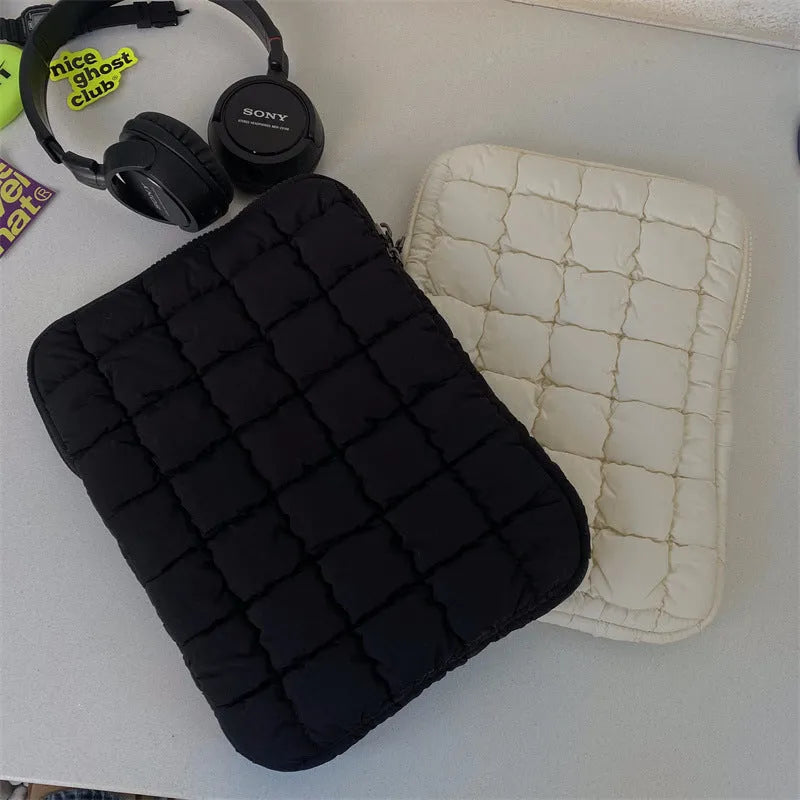 Black nylon laptop backpack open to show dedicated computer compartment with cloud cotton shoulder straps