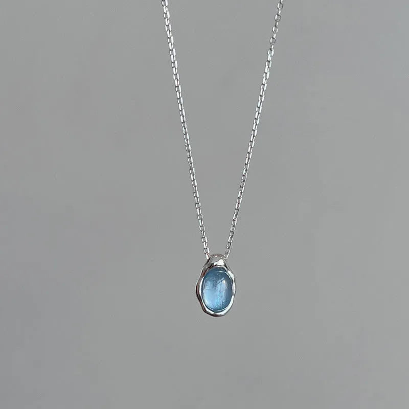 Women's navy blue water drop necklace with geometric pendant on adjustable cross chain