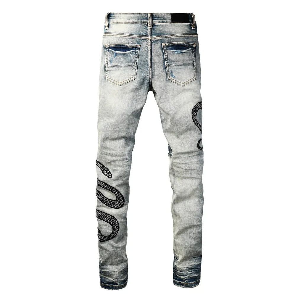 Distressed blue skinny jeans with wash detailing and button fly on mid waist design