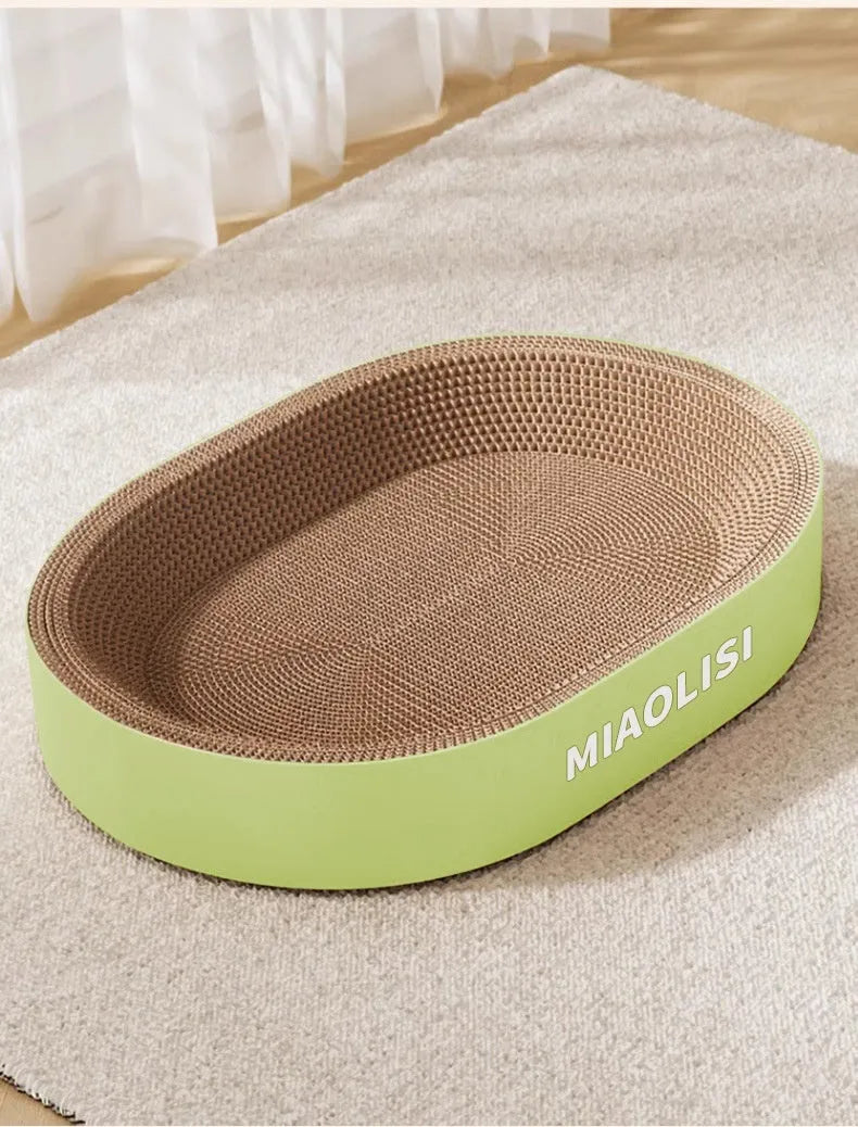 Green oval corrugated paper cat scratch board and nest bed, 55cm diameter.