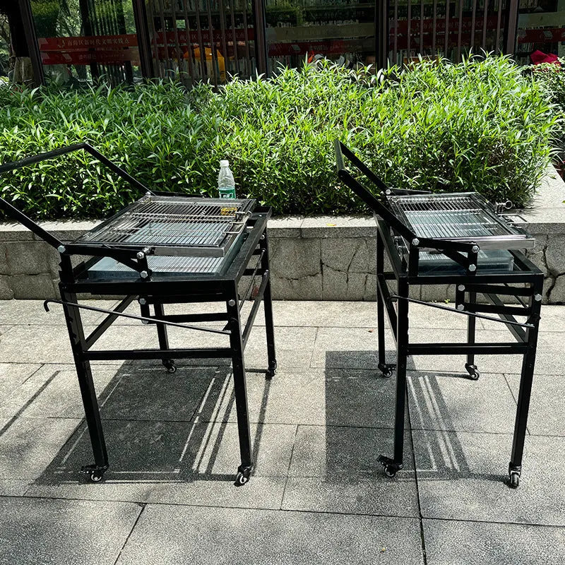 Foldable charcoal barbecue stove with large grill shown in courtyard setting
