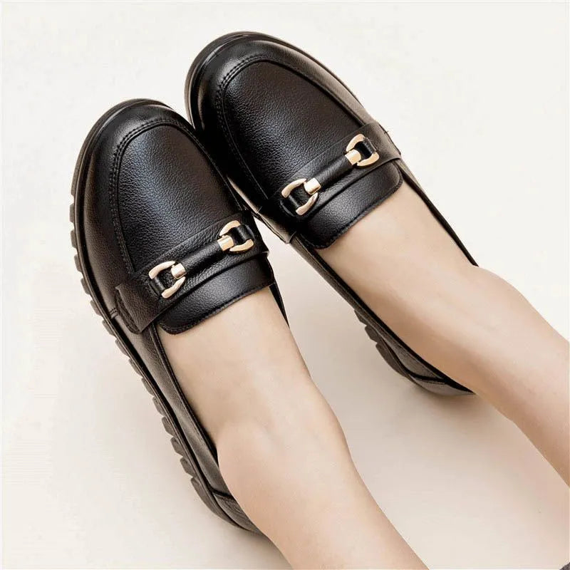 Black women's microfibre slip-on pumps with a round toe and low flat heel on a rubber sole.
