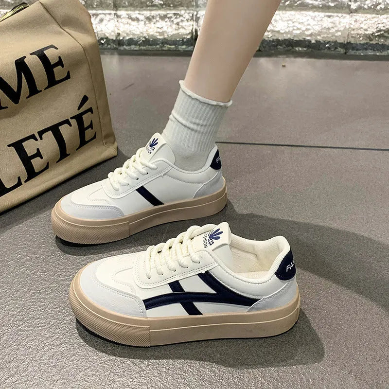 Blue and brown low-top lace-up board shoes with patent leather upper and flat rubber sole.