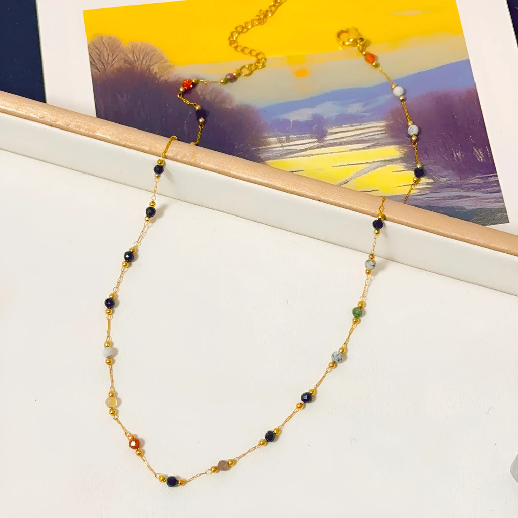 Gold coloured titanium steel necklace with natural stone pendant on O-ring chain.