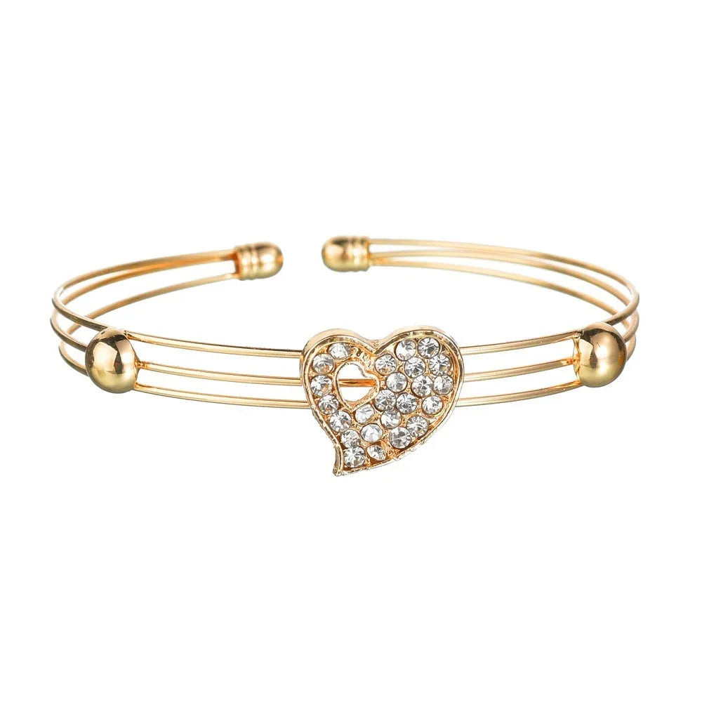 Gold tone women's love jewellery set with earrings, pendant and bracelet featuring adjustable 21-50cm sizing