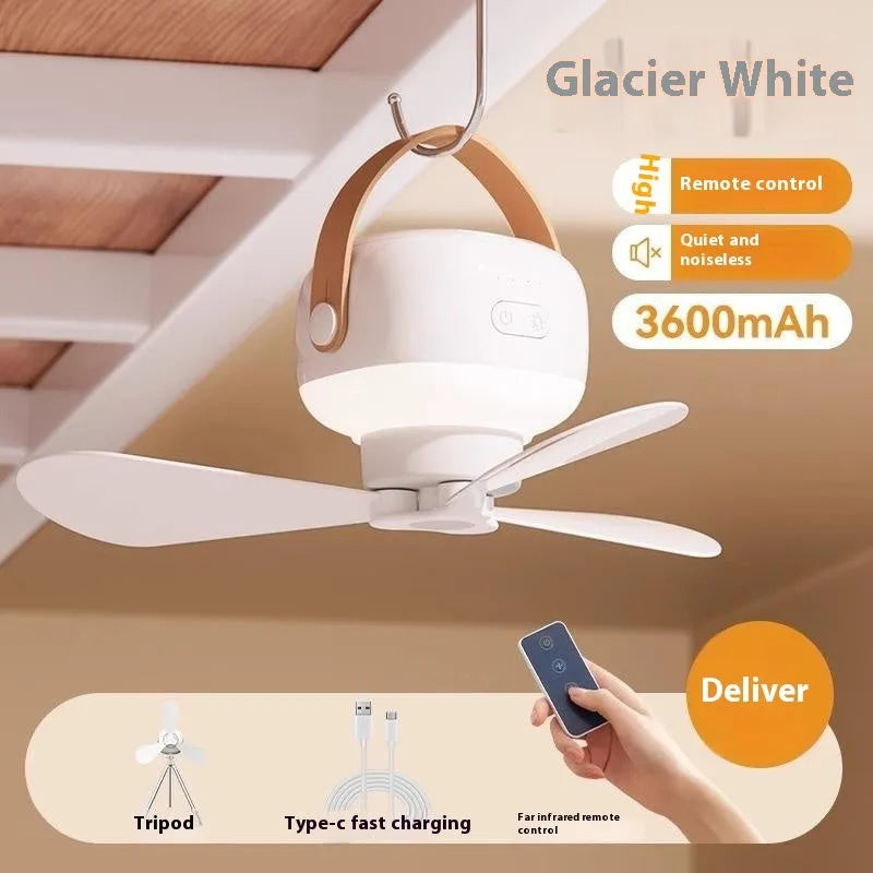 Small white rechargeable ceiling fan with fan blades and night light, hanging from a metal wire bracket for camping