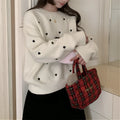 Women's acrylic pullover sweater with embroidery detail in milky white colour showing loose fit design