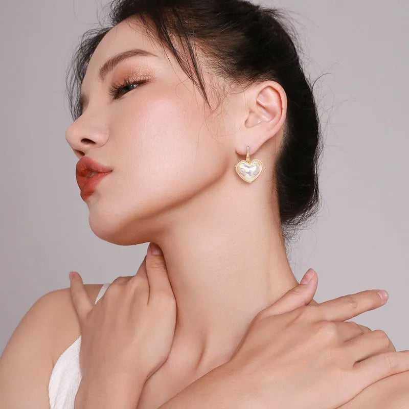 A pair of gold-coloured alloy clip-on earrings for women in a natural style.