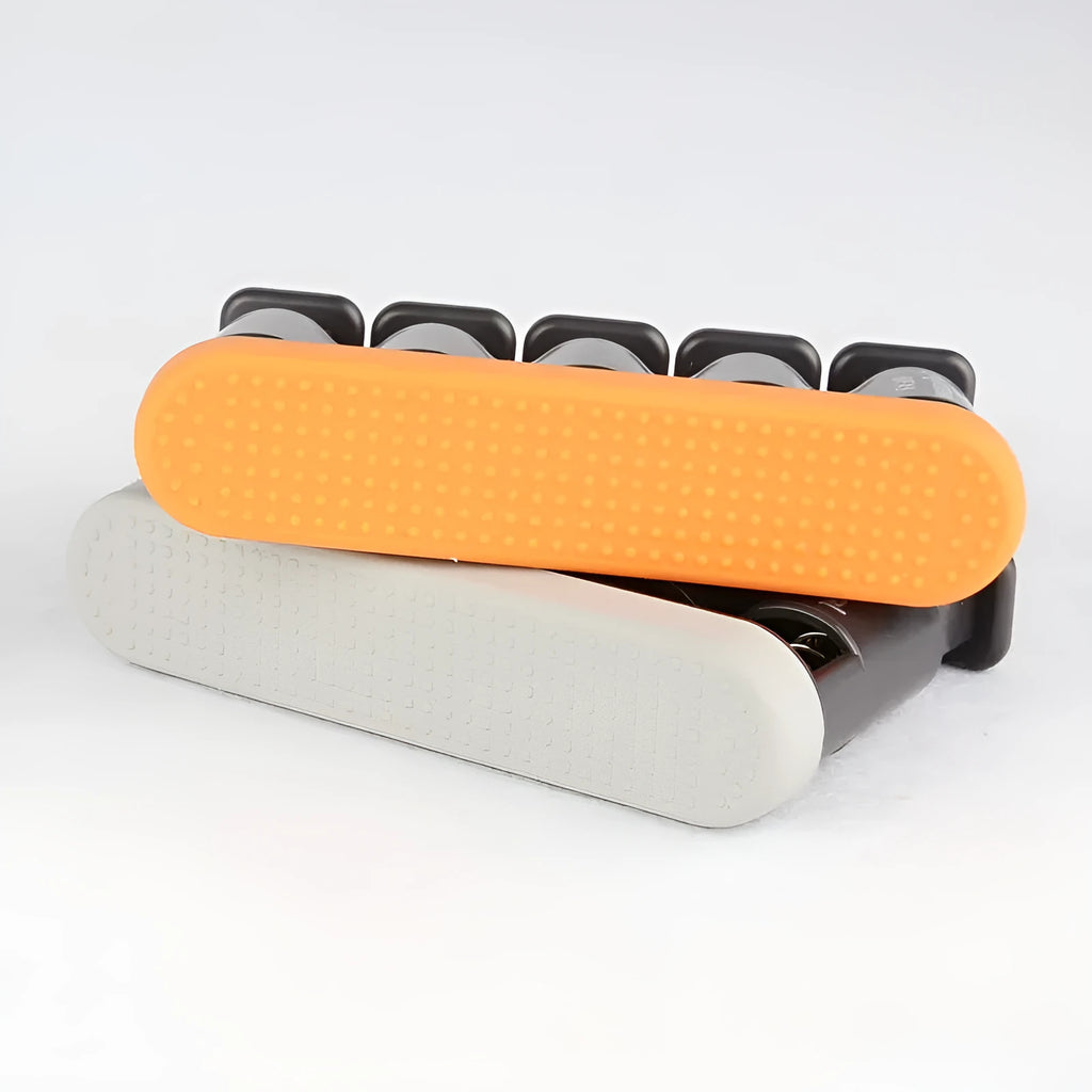 Grey and orange silicone finger trainer for hand strength development in piano, guitar, guzheng practice.