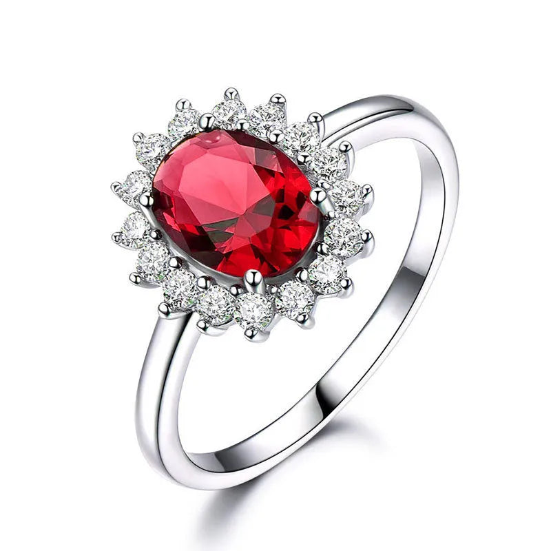 Women's copper flower ring with moissanite inlay in sapphire blue, red, or green on a model's hand.