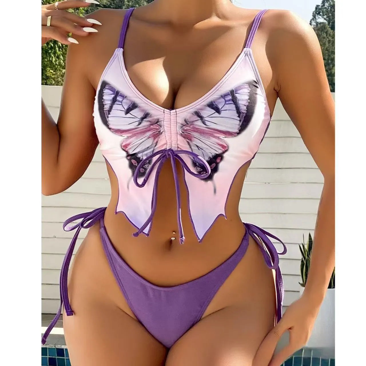 Women's purple bow ins style split bikini set with briefs, on a mannequin.
