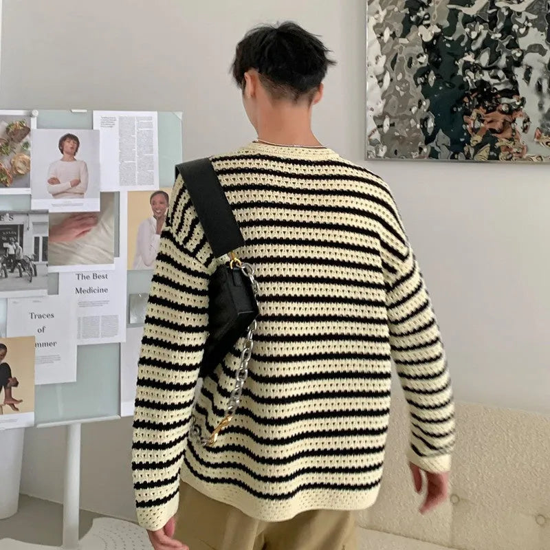 Men's black cotton blend long sleeve loose fit sweater on a hanger, front view