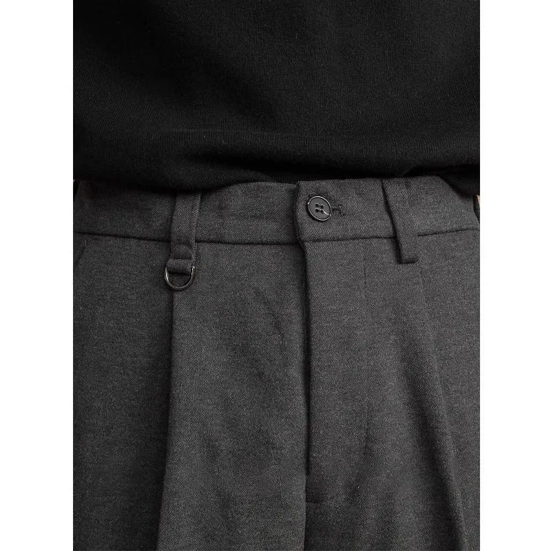 Men's straight-leg suit trousers in a draped fit, shown in a neutral colour.