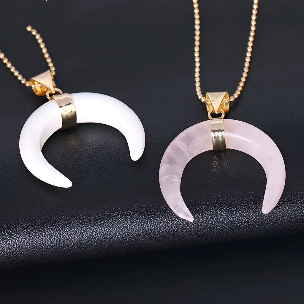 Close-up of a pink natural stone moon pendant necklace on a 45cm chain with electroplated copper fittings.