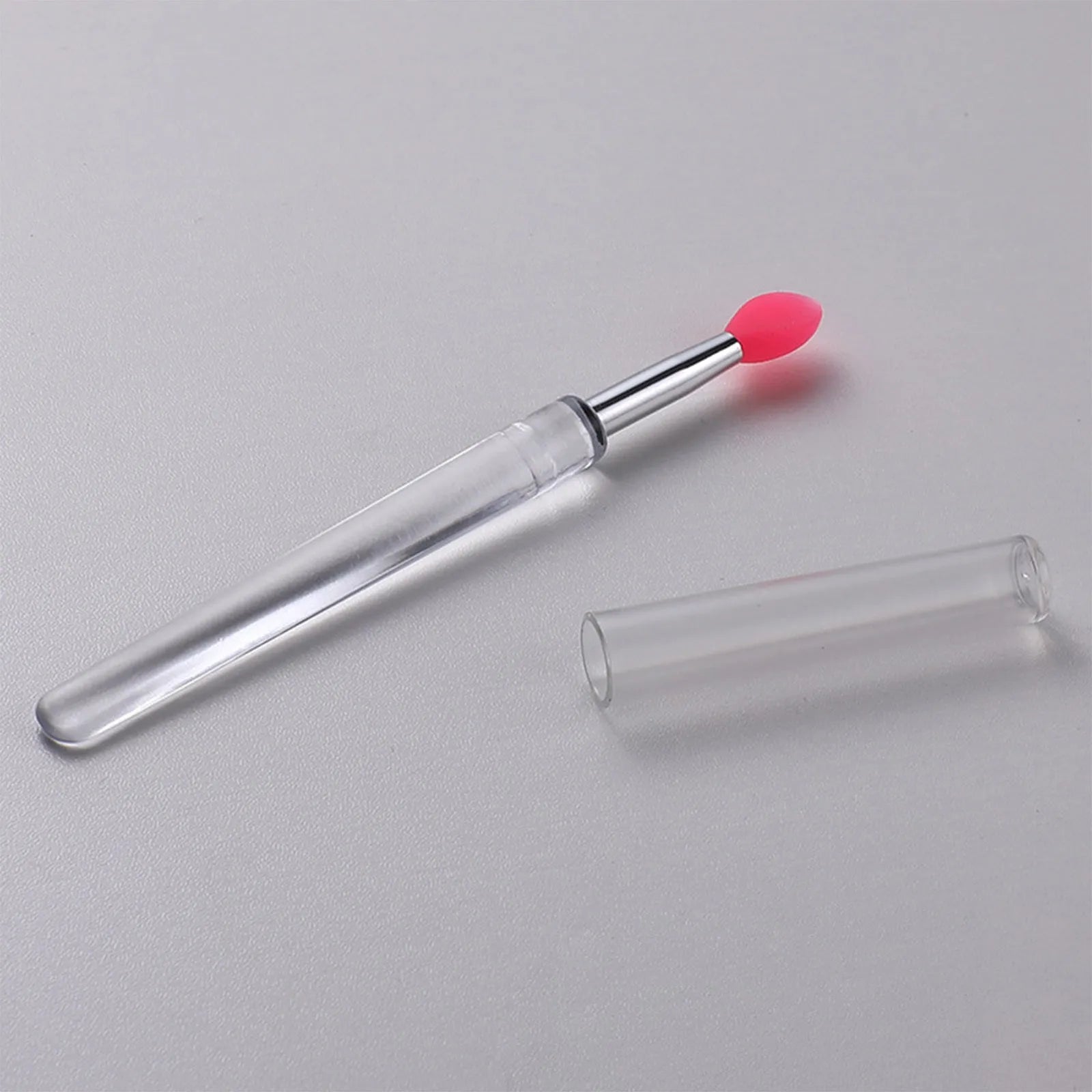 Set of four reusable silicone lip brushes with protective caps in assorted colours