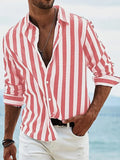 Man wearing a loose grey striped long-sleeved casual shirt with a cardigan style.