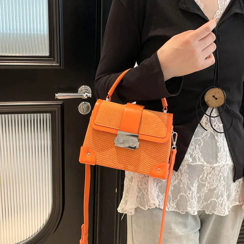 PU crossbody bag in horizontal square shape with sandwich outer pocket and seven colour options including black and orange