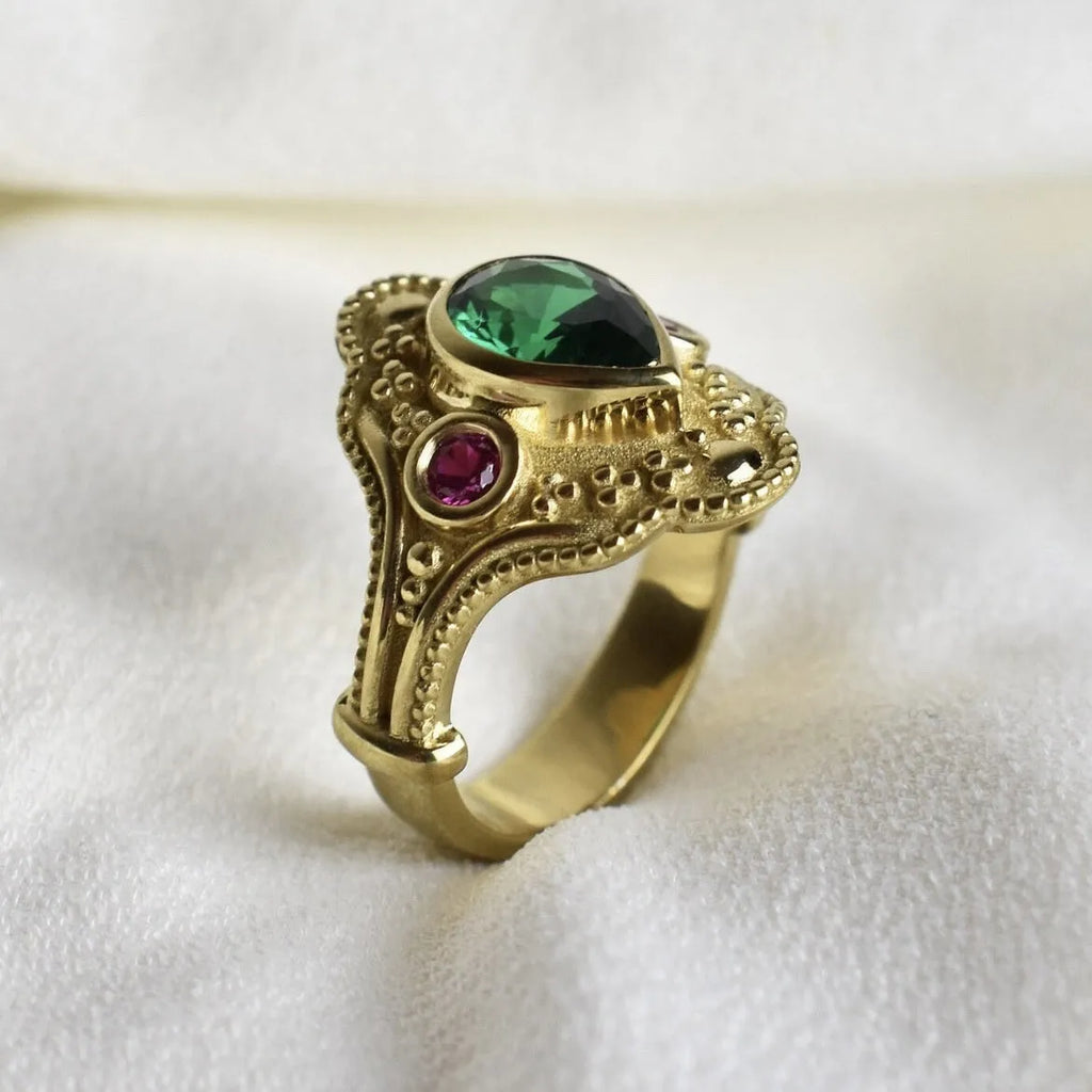 Gold-plated women's alloy ring with geometric shape and lvzuan colour on a white background.