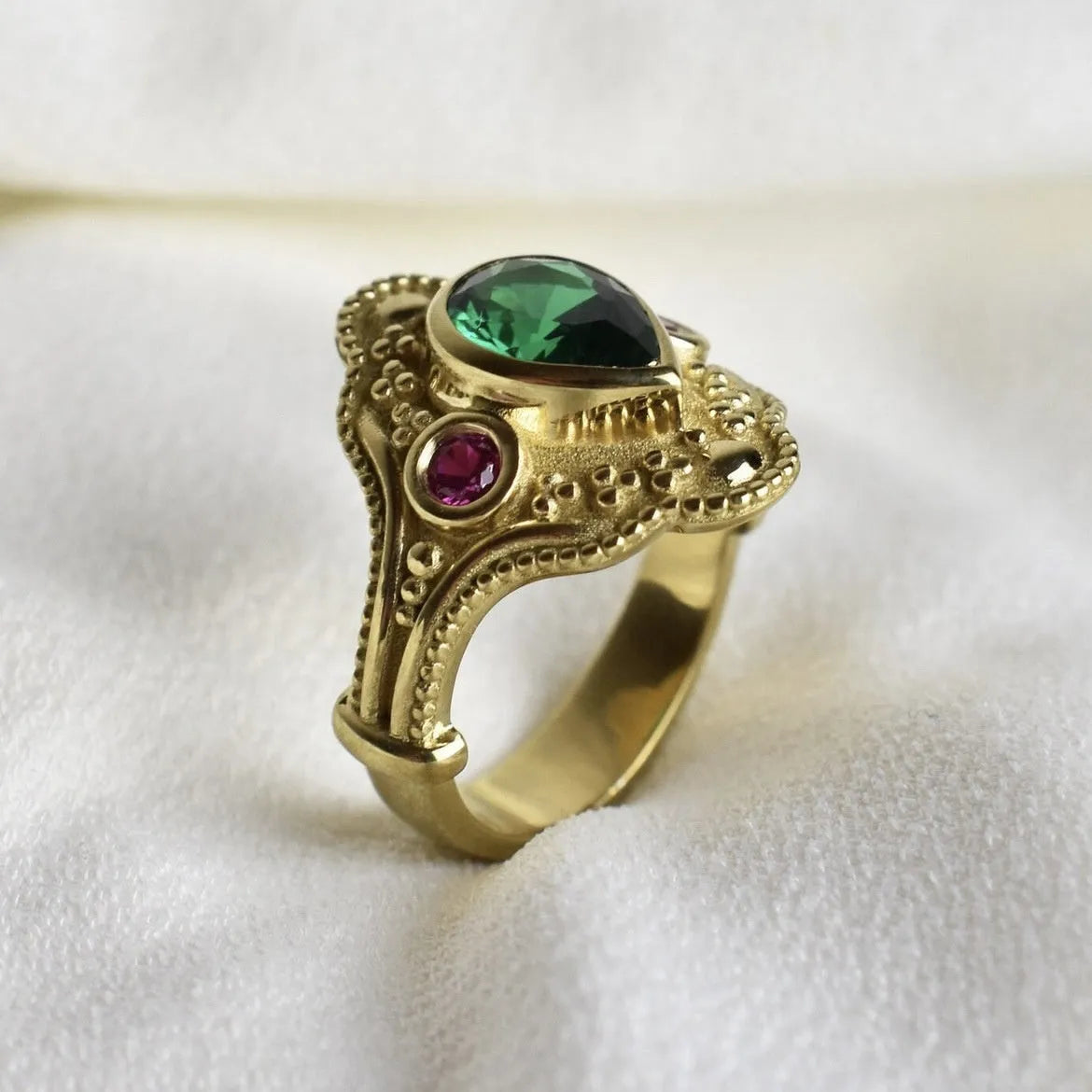 Gold-plated women's alloy ring with geometric shape and lvzuan colour on a white background.