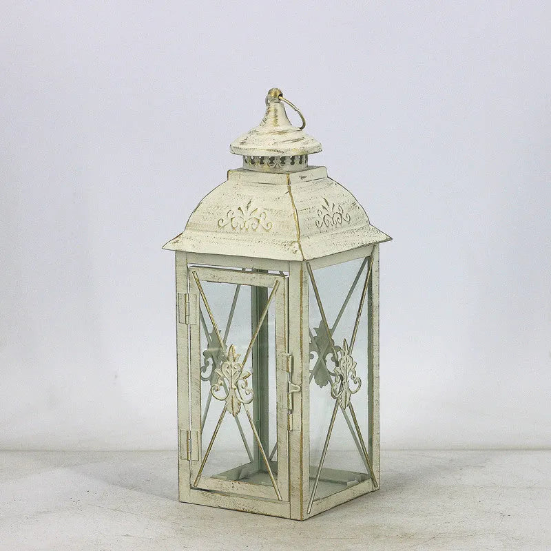 Black and white wrought iron floor-standing storm lantern with tempered glass panels in three sizes for courtyards.