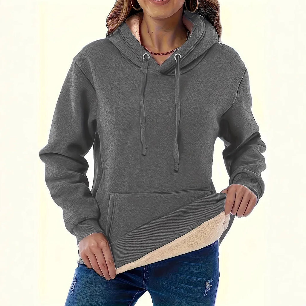 Women's black loose fit hooded sweater with pockets and long sleeves laid flat.
