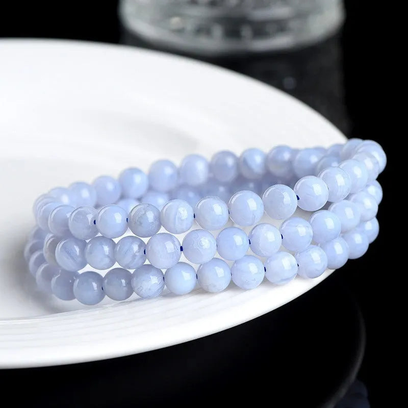 Natural blue agate bracelet with multi-circle patterns and scattered Ruyi elements on wrist