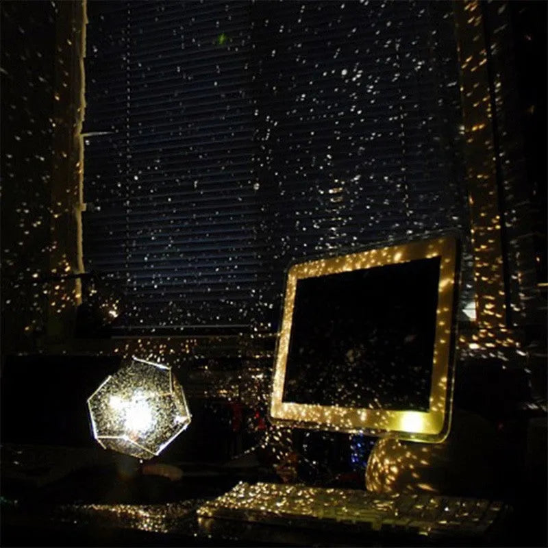 A white plastic LED star projector night light with remote control on a table.