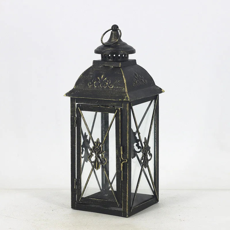 Black and white wrought iron floor-standing storm lantern with tempered glass panels in three sizes for courtyards.