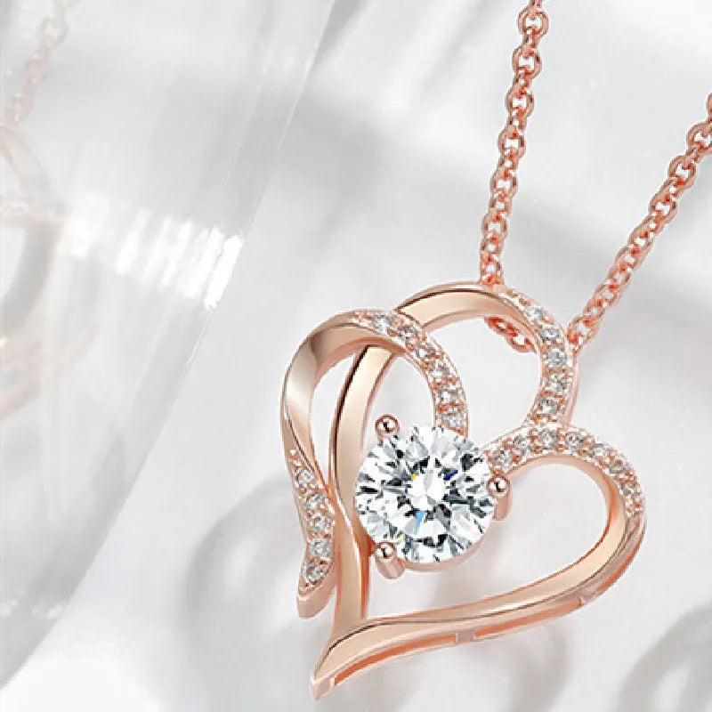 Close-up of a women's heart-shaped pendant necklace in 925 silver with a diamond-treated finish