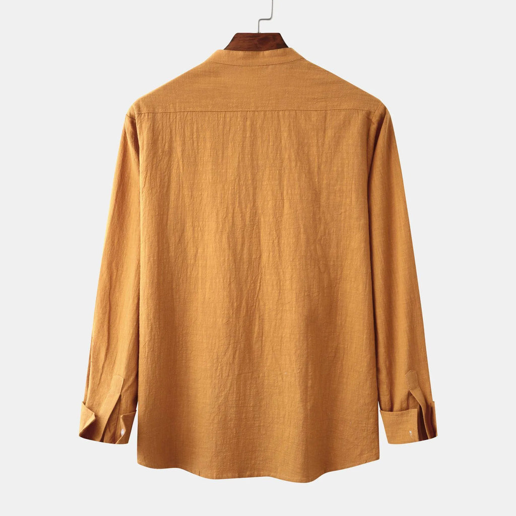 Men's slim fit brown cotton blend long sleeve shirt and matching casual trousers laid flat.