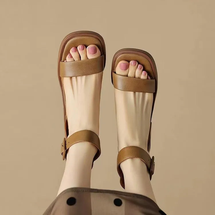 Women's white retro ankle-strap platform high heels with a round toe on a plain background.