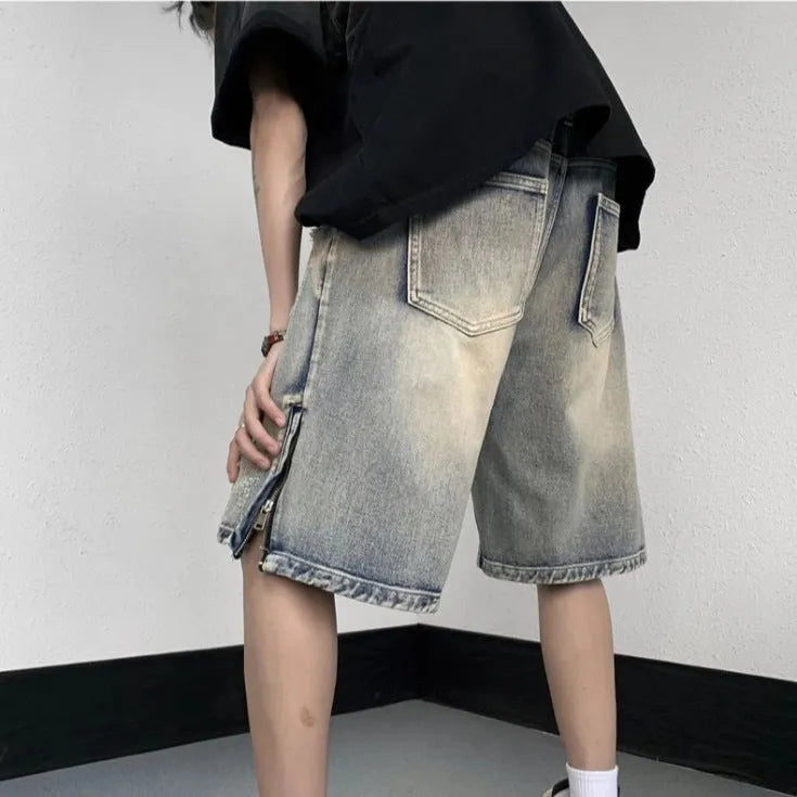 Blue retro denim shorts with a tattered finish and loose wide-leg cut on a mannequin