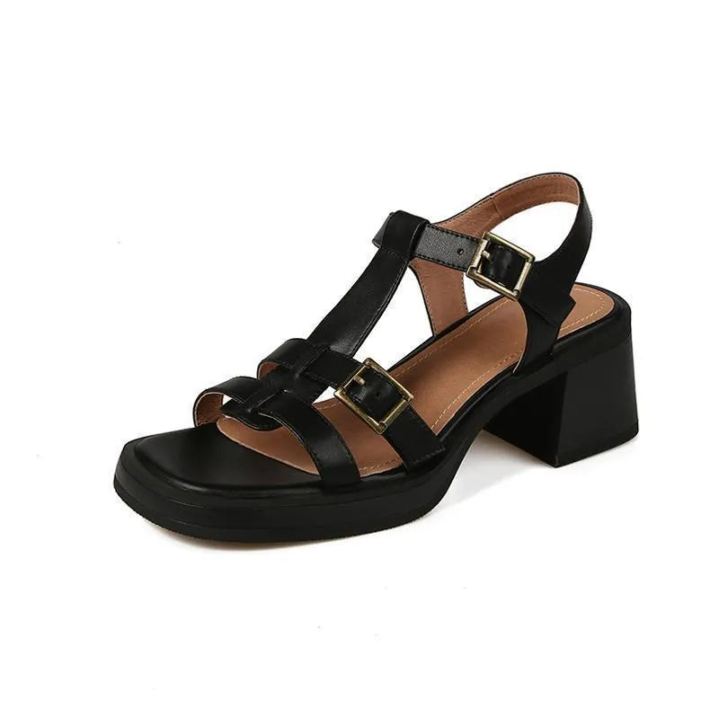 Women's black retro platform sandals with chunky heel and T-buckle strap on a white background.