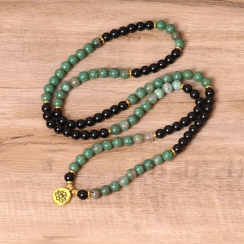 Green and black alloy elastic beaded bracelet showing alternating colours on wrist